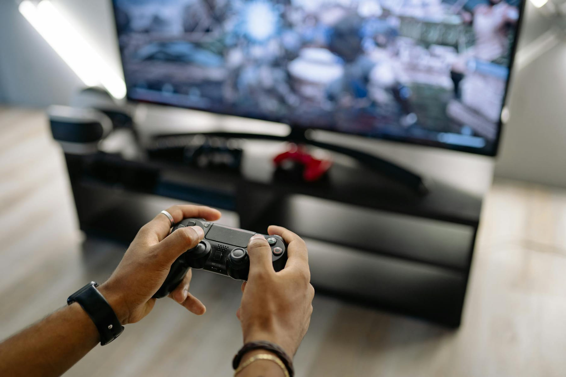 Close-up of hands holding a gaming controller while playing video games indoors. on Quest on Chain