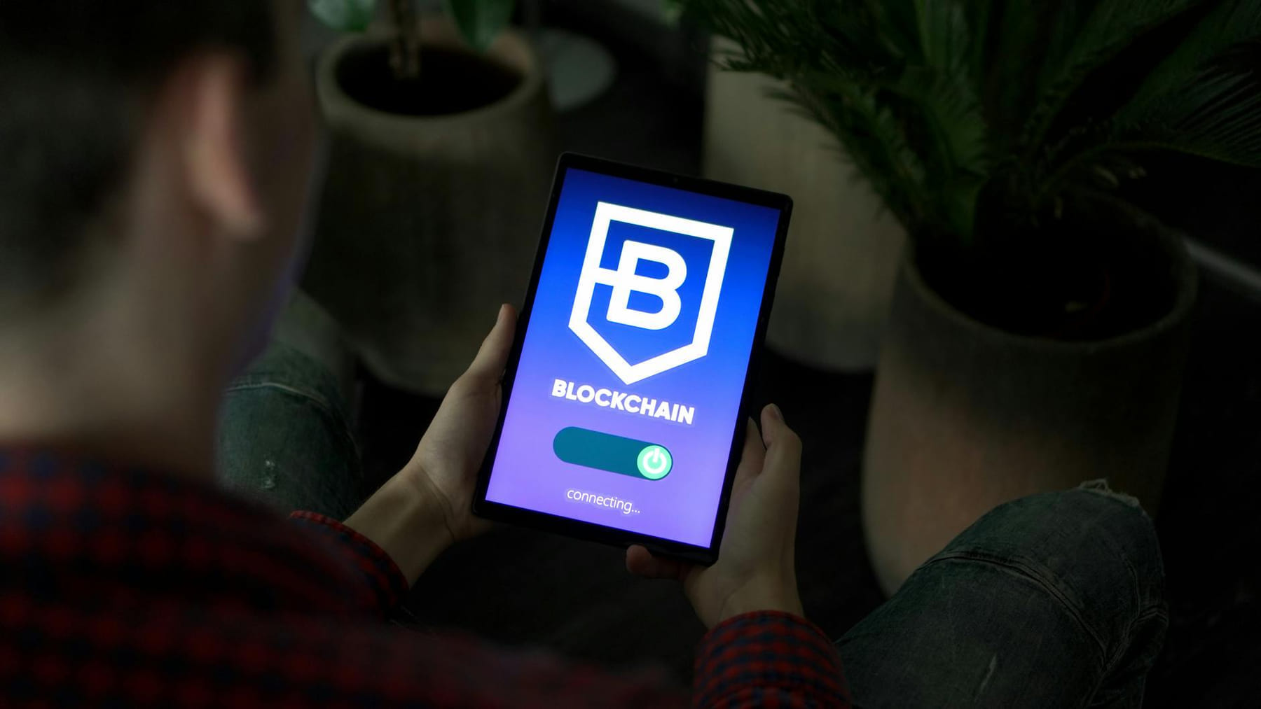 Person holding a digital tablet showing blockchain connection screen indoors. on Quest on Chain