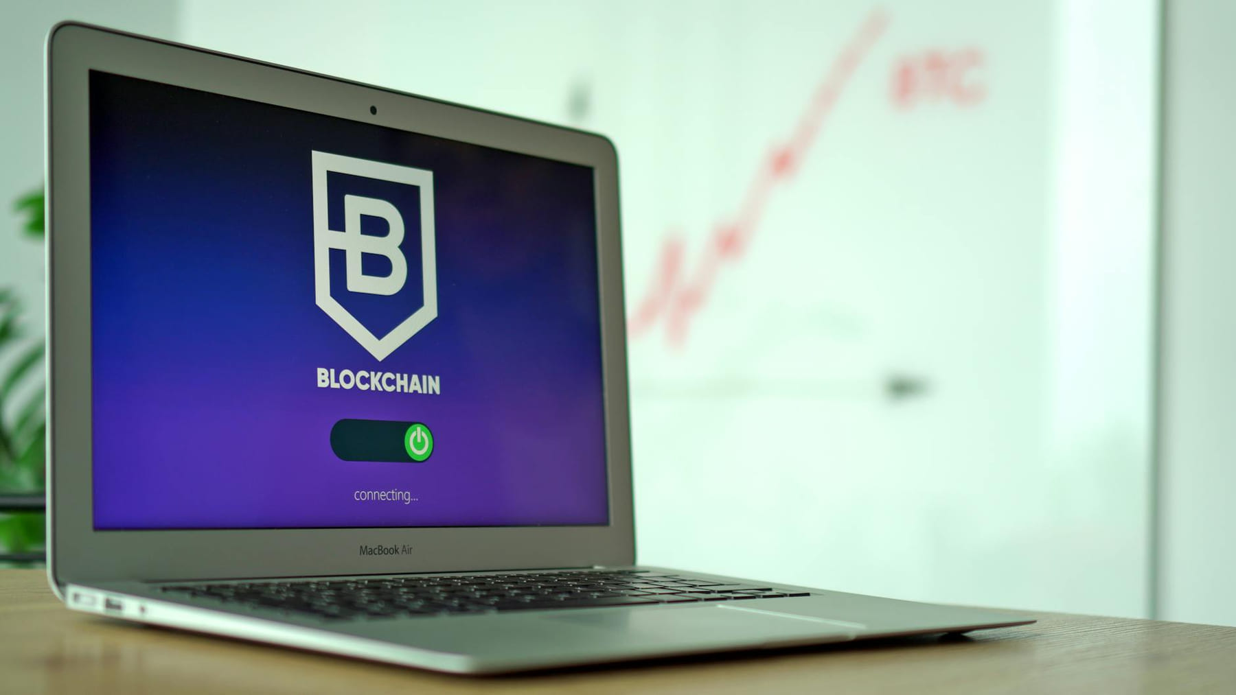 MacBook Air showing a blockchain application interface in an office setting. on Quest on Chain