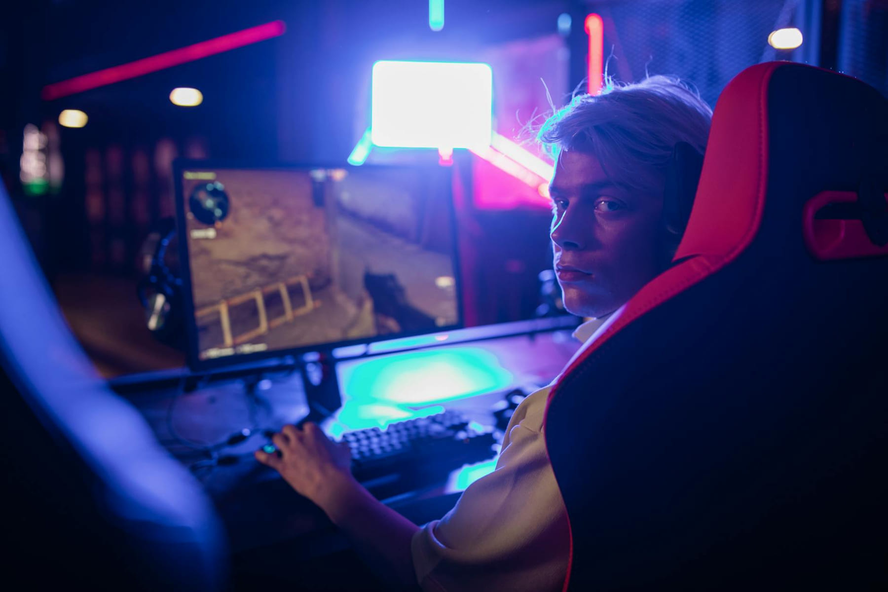 Gamer focused on intense video game session in a neon-lit room. on Quest on Chain
