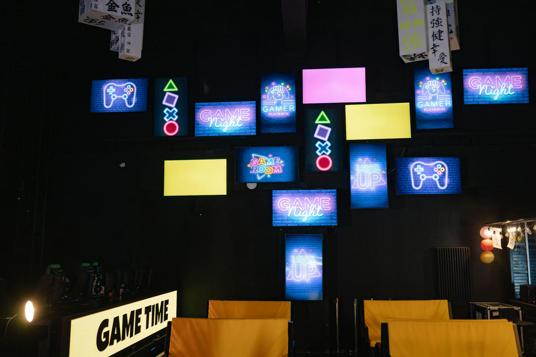 A lively gaming room displaying bright neon signs and screens, creating an immersive atmosphere. on Quest on Chain