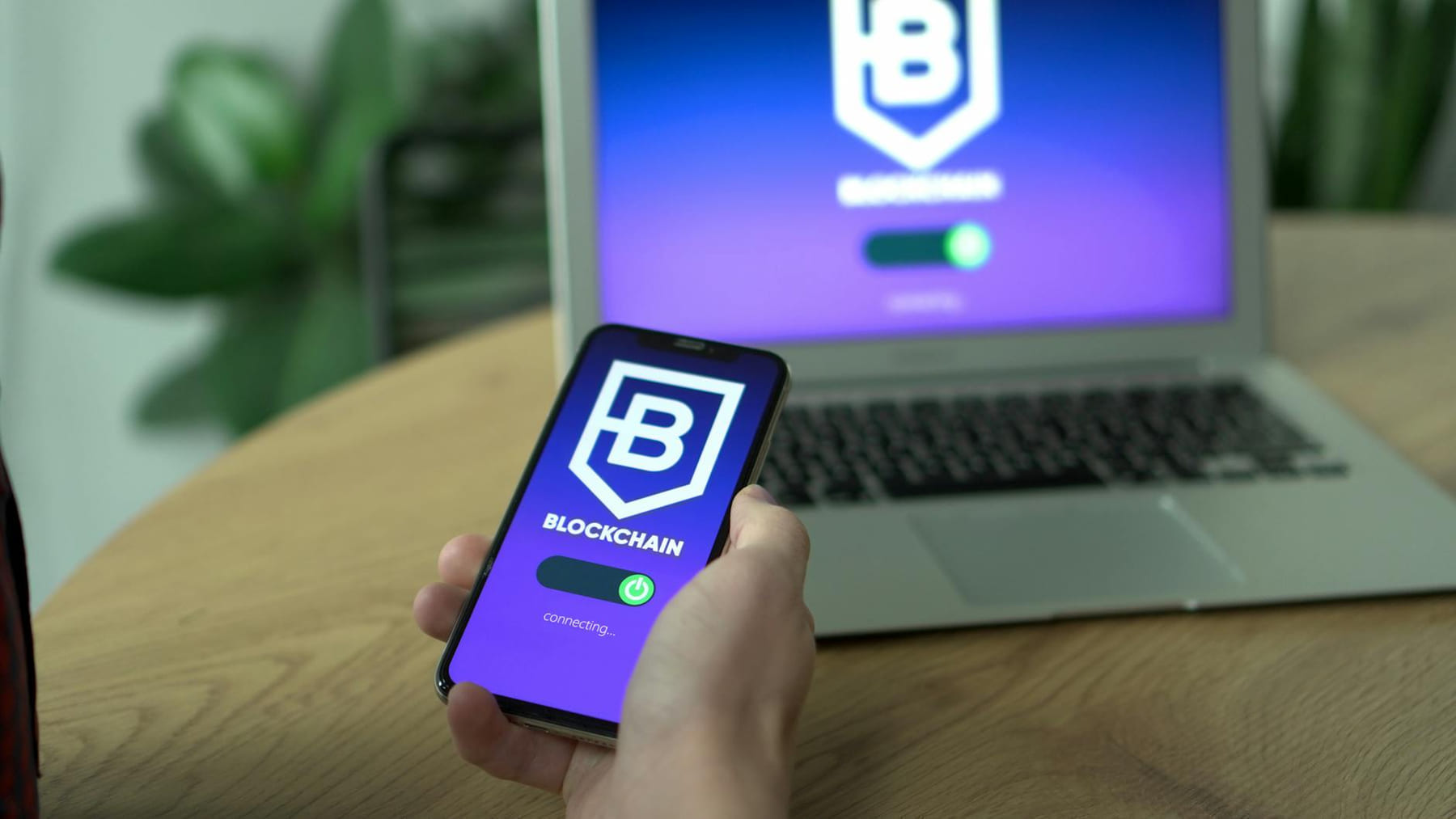 Person uses a blockchain application on smartphone, mirrored on laptop screen. on Quest on Chain