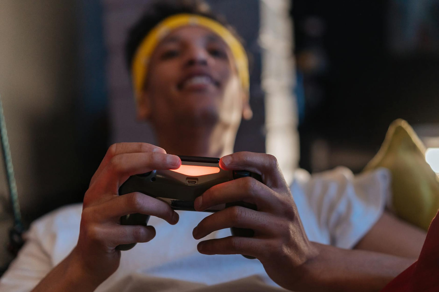 A relaxed gaming session with a close-up view of a man holding a game controller indoors. on Quest on Chain