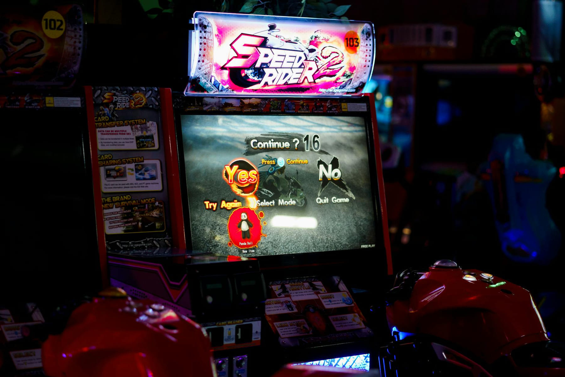 Close-up of an arcade gaming machine screen in a lively amusement center, offering speed racing game options. on Quest on Chain