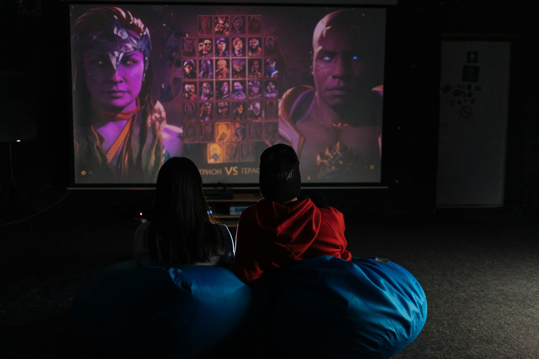 Two friends enjoying a video game session on a projector screen, immersed in gameplay. on Quest on Chain