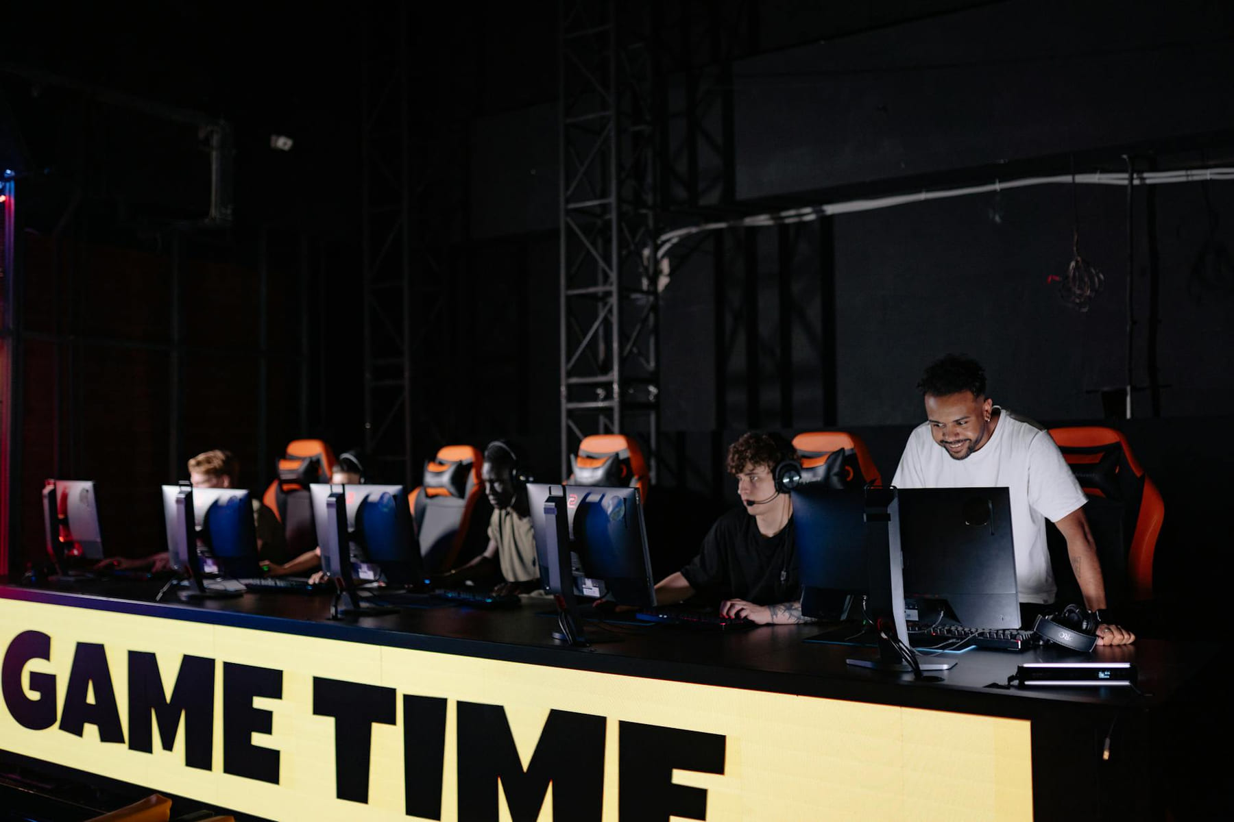 Esports team engaged in competitive gaming session indoors, showcasing teamwork and concentration. on Quest on Chain